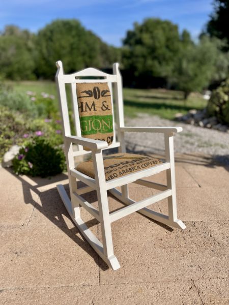 Decorative antique child's rocking chair upholstered with a coffee sack