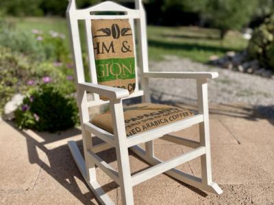 Decorative antique child's rocking chair upholstered with a coffee sack