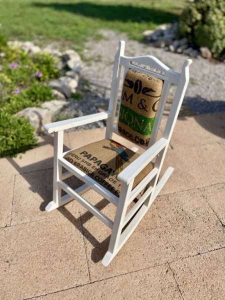 Decorative antique child's rocking chair upholstered with a coffee sack