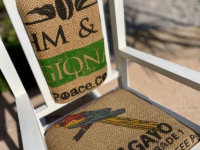 Decorative antique child's rocking chair upholstered with a coffee sack