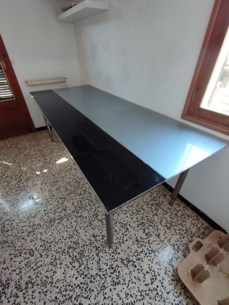 Glass table with stainless steel base