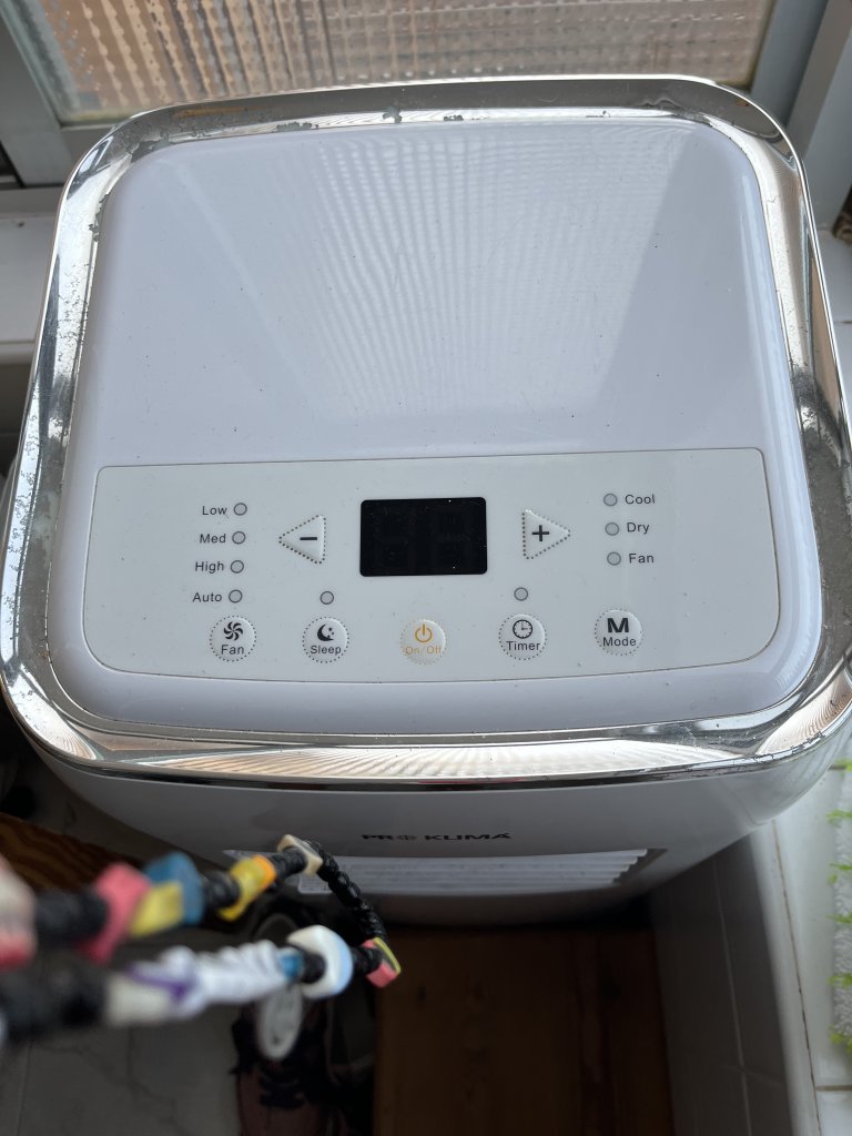 Mobile air conditioner with exhaust hose