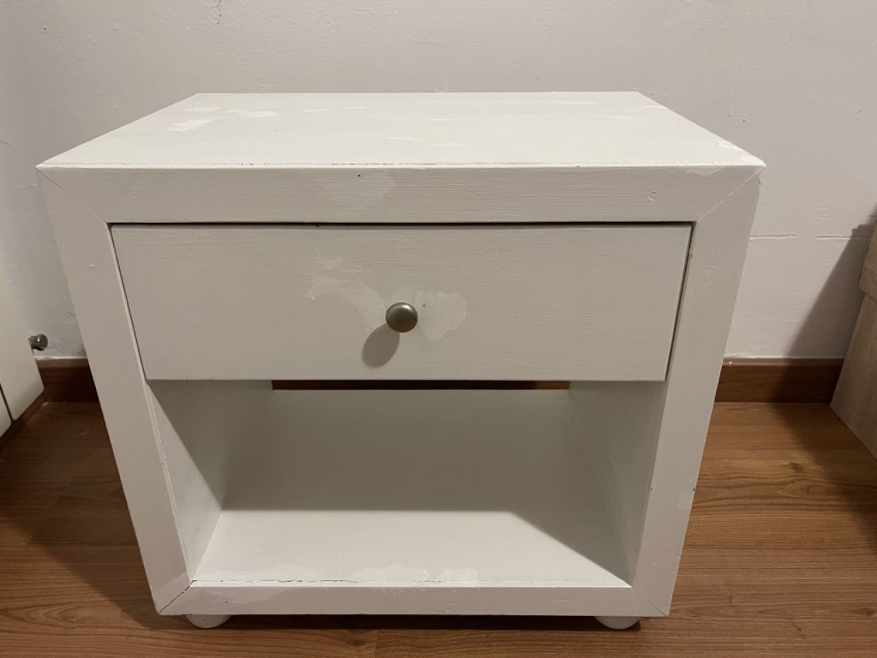White wooden bedside table with drawer