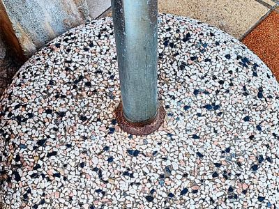 Round umbrella stand made of concrete and stainless steel tube with new sun umbrella